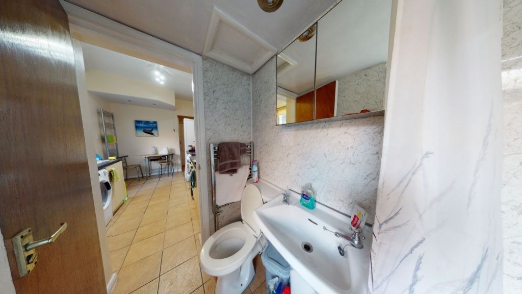 Property photo 3 of 8 A Neat Bathroom Featuring A White Sink With Mirror...