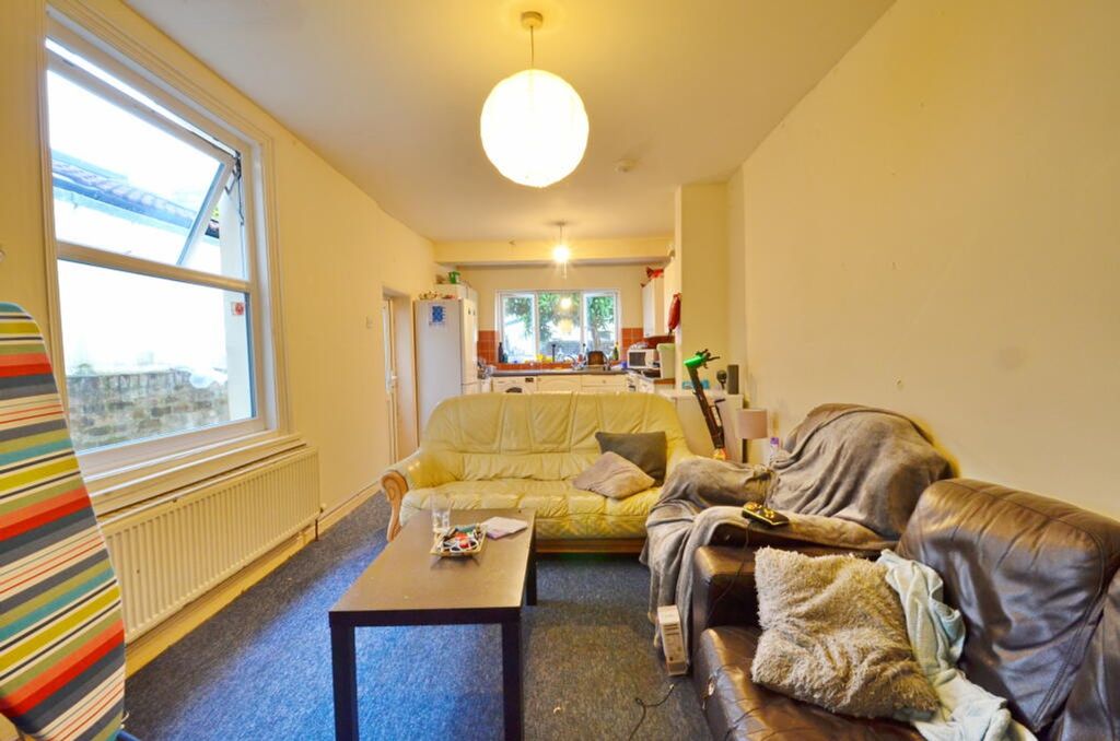 Property photo 2 of 7 A Spacious And Inviting Living Room Featuring Comf...