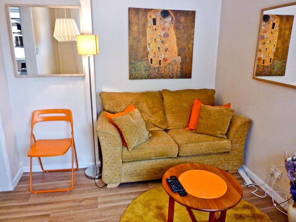 Property photo 2 of 5 A Cozy Living Room Featuring A Comfortable Sofa Ad...