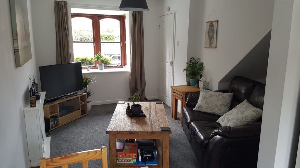 Property photo 1 of 9 A Bright And Cozy Living Room Featuring A Large Wi...