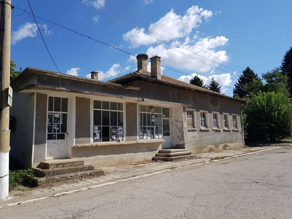 Property photo 2 of 34 Side Perspective Of The Bakery Building Showing Entrance Doors And Windows With Posted Notices