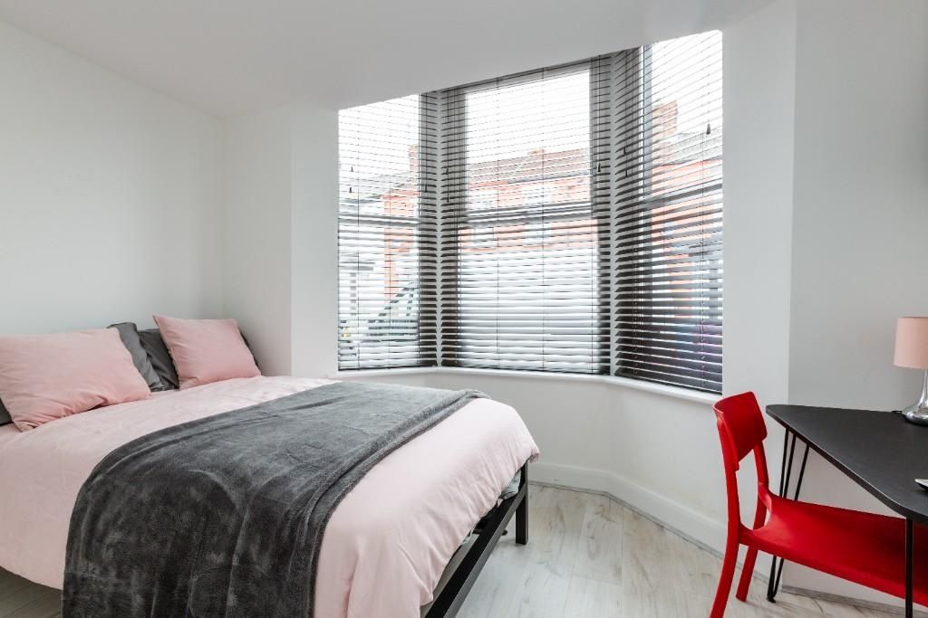Property photo 2 of 15 A Bright And Welcoming Bedroom Featuring A Large W...