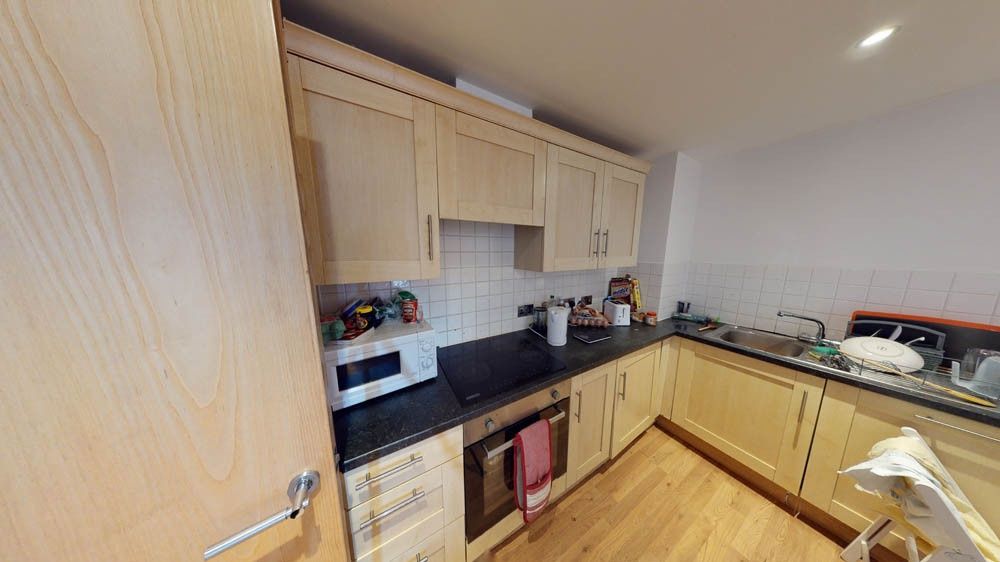 Property photo 1 of 5 A Modern Kitchen Featuring Light Wood Cabinets And...