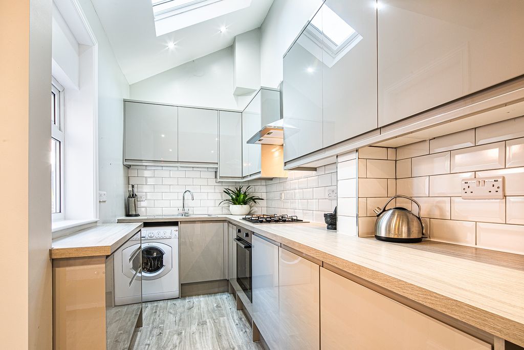 Property photo 2 of 24 Modern, Well-Maintained Kitchen Featuring Sleek Ca...