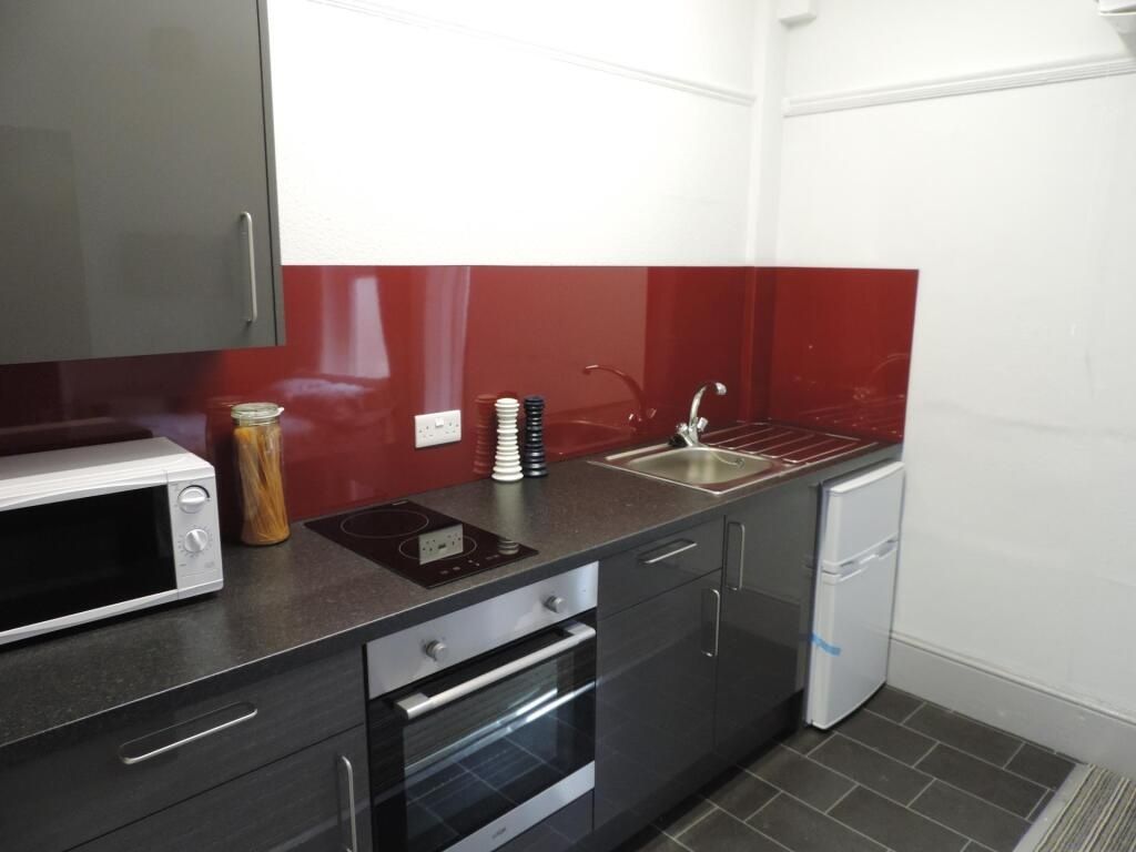 Property photo 2 of 3 Modern Kitchen With Sleek Red Splashback...