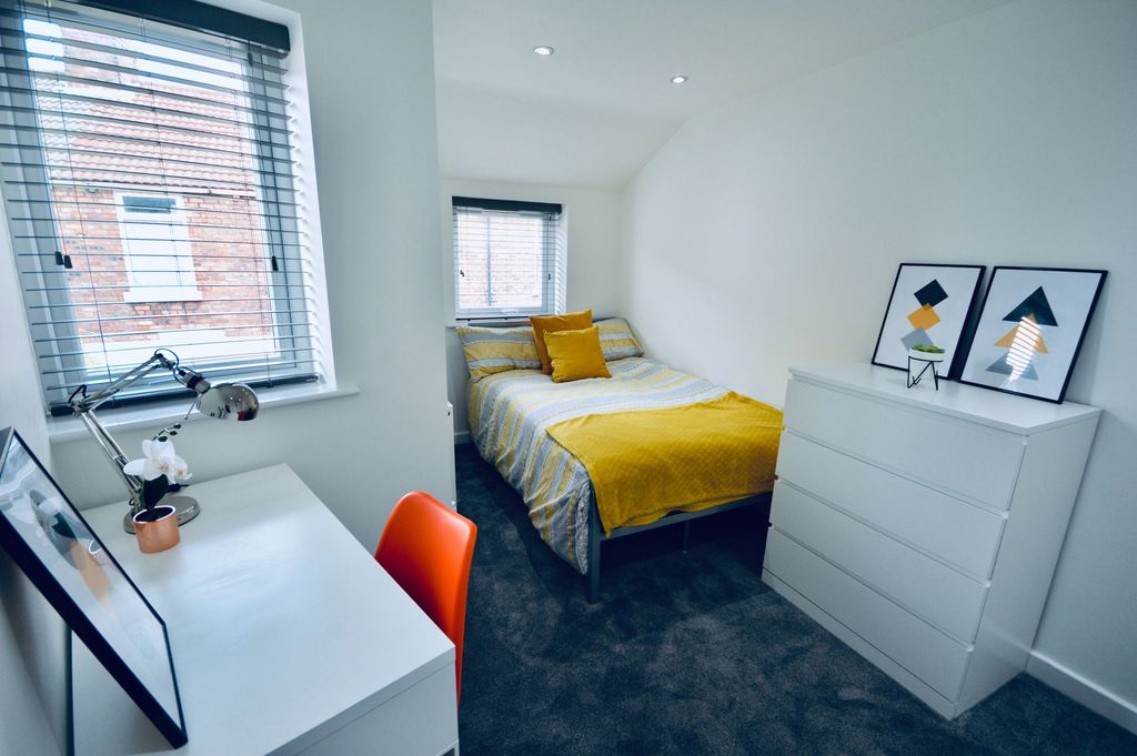 Property photo 3 of 4 Bright And Inviting Bedroom With A Cozy Bed Dresse...