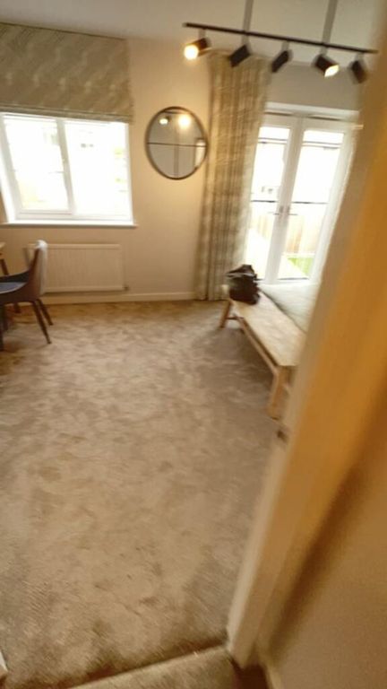 Property photo 2 of 5 A Cozy Living Room Featuring Large Windows That In...