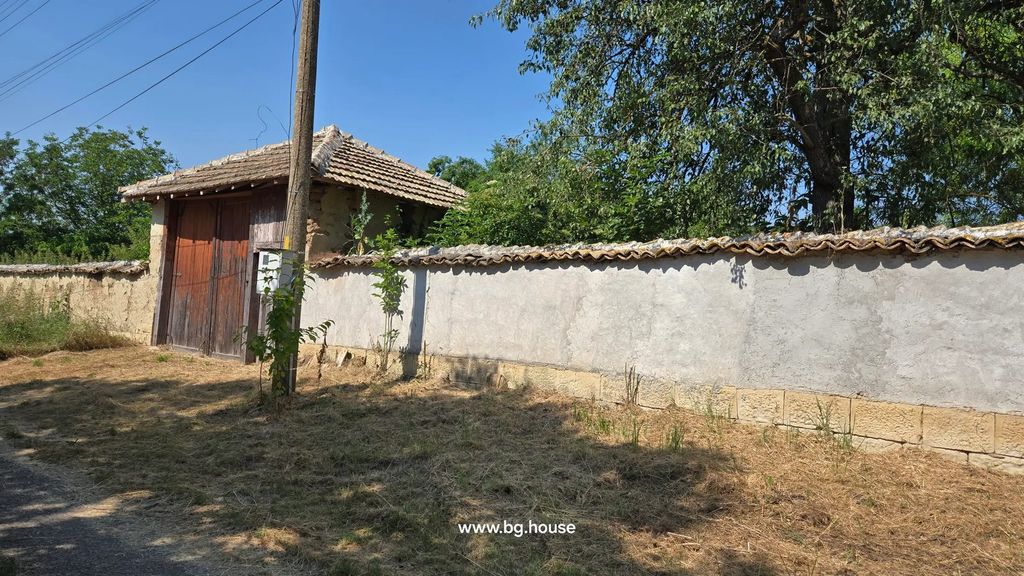 Property photo 3 of 100 View Of The Property Wall Featuring A Large Wooden Gate And A Utility Pole, With Dry Grass And Trees.