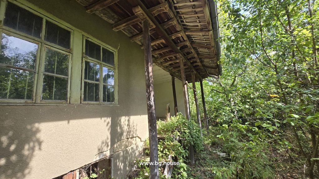 Property photo 1 of 47 Traditional Bulgarian House Exterior Showing Wooden Roof Supports And Surrounding Greenery.