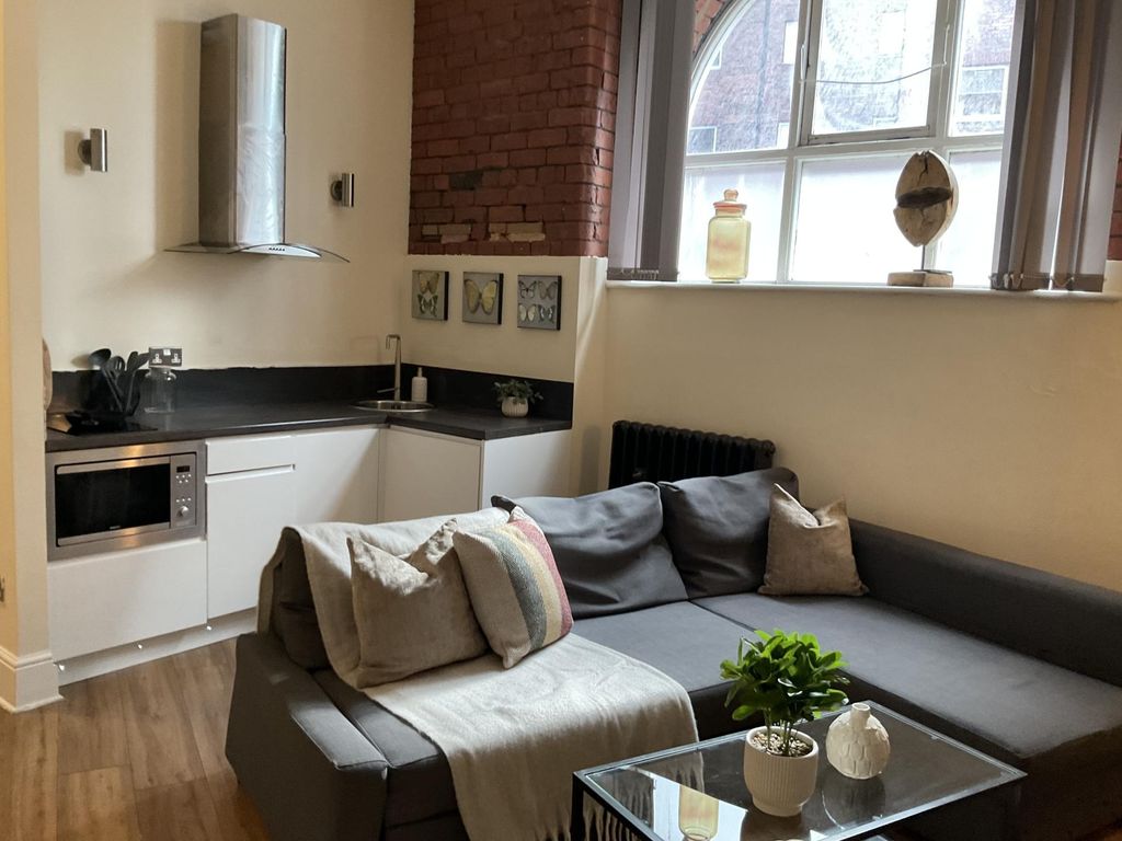 Property photo 3 of 16 A Cozy And Modern Living Room Featuring A Comforta...