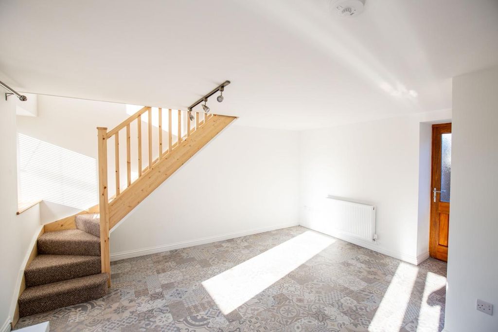Property photo 1 of 13 Bright And Airy Living Room Featuring Patterned Ti...