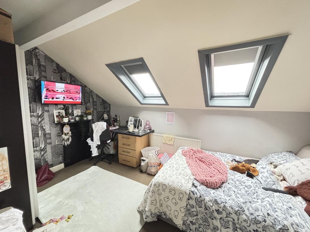 Property photo 1 of 14 A Bright And Cozy Bedroom Featuring Two Neatly Mad...
