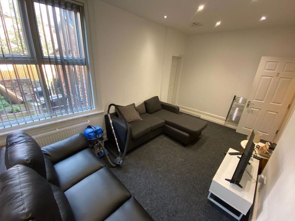 Property photo 1 of 25 A Modern And Inviting Living Room Featuring Contem...