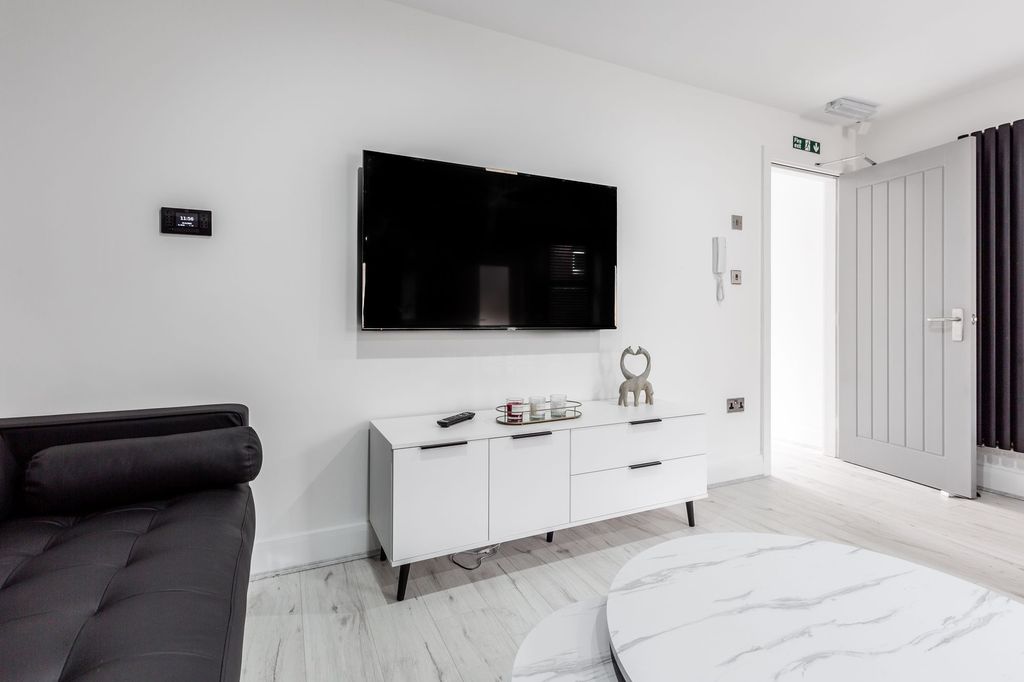 Property photo 3 of 6 Modern And Stylish Living Room Featuring A Large F...