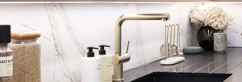 Property photo 3 of 4 Closeup Of Kitchen Black Countertops, Chrome Taps, Marble Texture Splashbacks, Strip Lighting Above.
