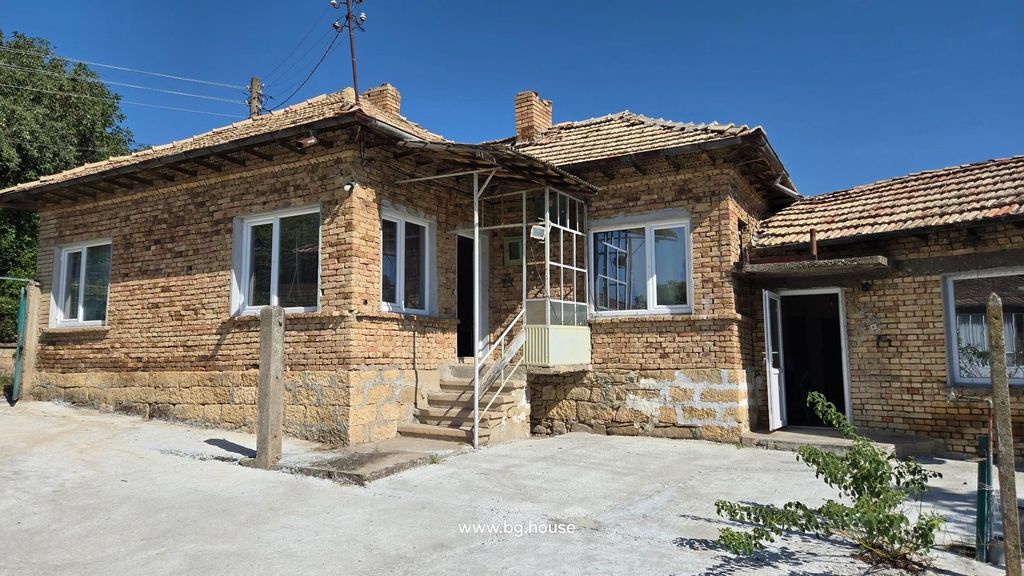 Property photo 2 of 41 Brick House With Tiled Roof, White Framed Windows, Entrance With Stairs And Metal Railing, Concrete Yard In Front Under Clear Blue Sky