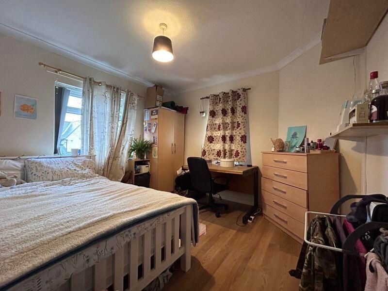Property photo 3 of 10 A Cozy Bedroom Featuring A Neatly Made Bed, A Desk...