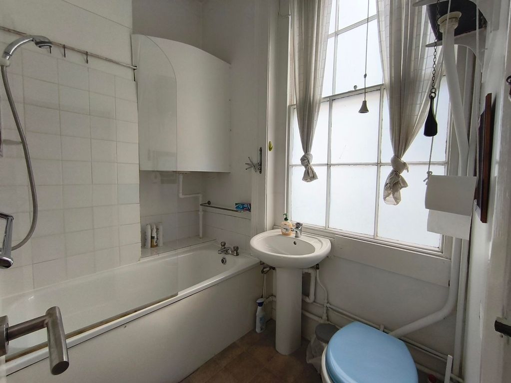 Property photo 1 of 7 A Compact Bathroom Featuring A Bathtub With A Show...
