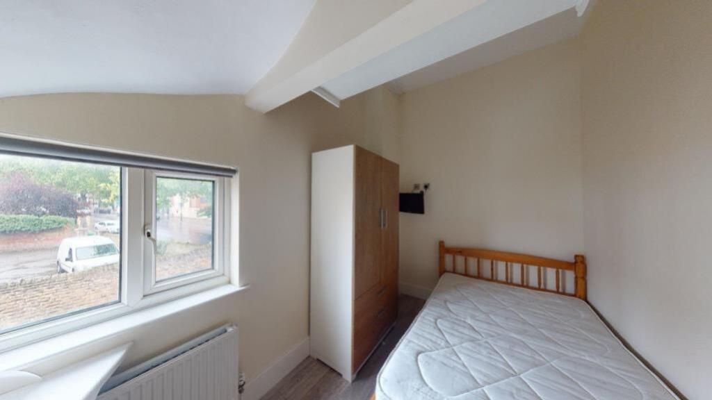 Property photo 1 of 6 A Cozy Single Bedroom Featuring A Wooden Bed Frame...