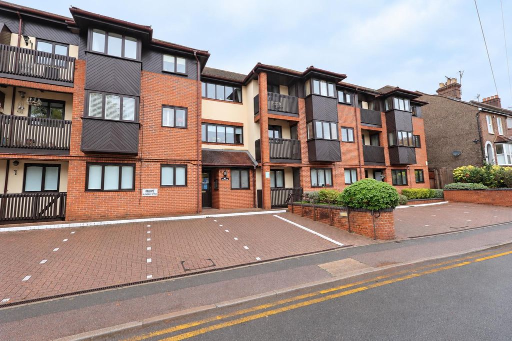 Property photo 1 of 10 Curbside View Of A Modern Apartment Complex.Png