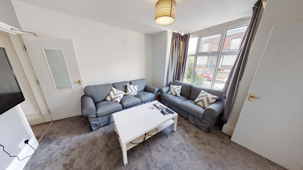 Property photo 2 of 8 A Bright And Cozy Living Room With A Comfortable B...