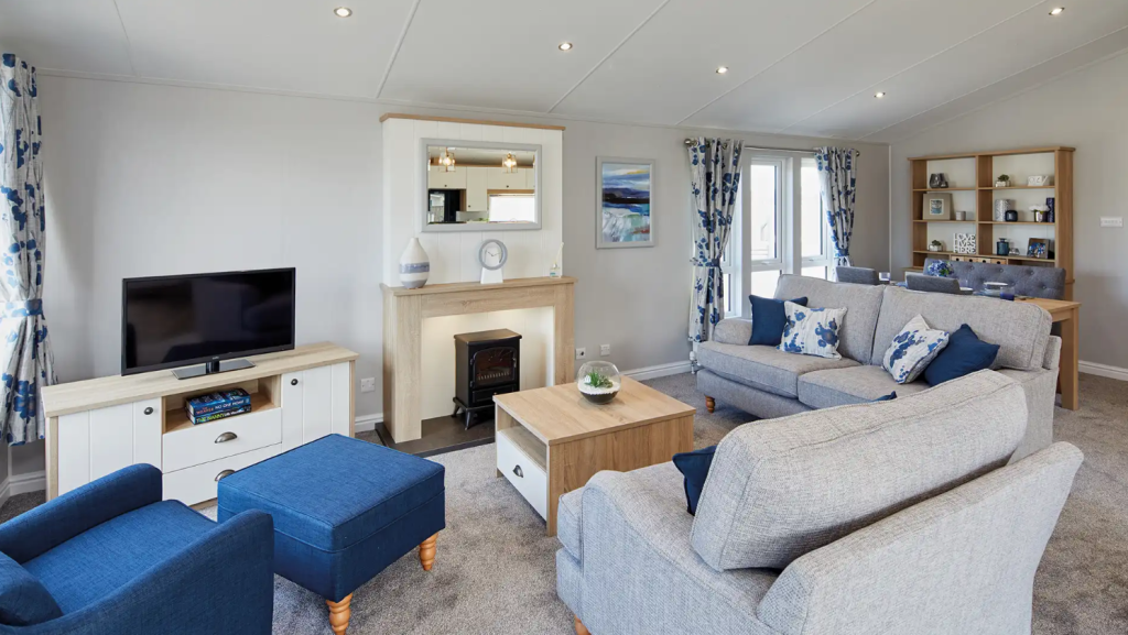 Property photo 3 of 11 Stylish Lounge With Grey Sofas, Blue Accents And Feature Fireplace
