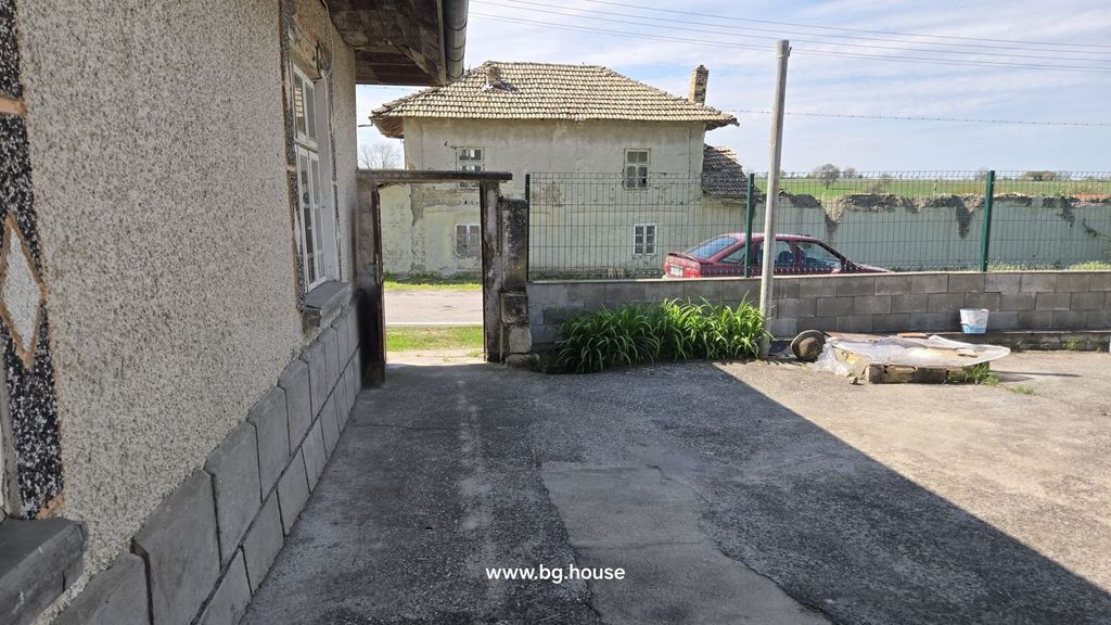 Property photo 2 of 41 Concrete Courtyard With Garden Plants Near The Open Gate Leading To The Street
