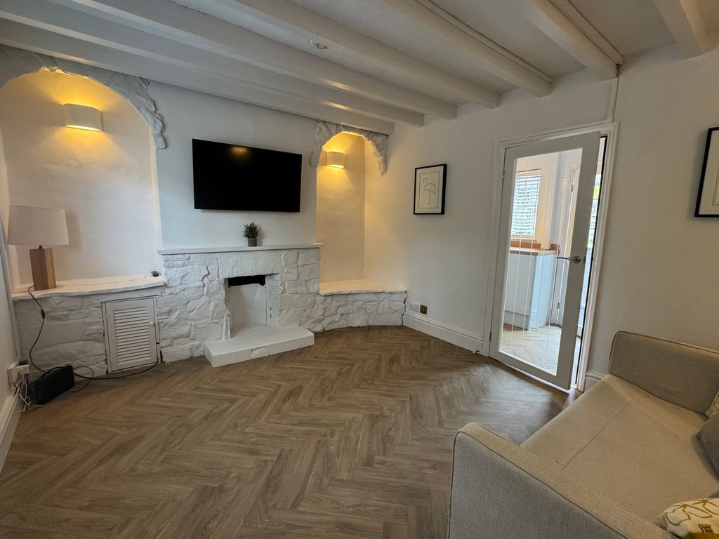 Property photo 1 of 9     Beautifully Renovated Living Space Featuring Exposed Beams, Herringbone Flooring, Smart TV And S