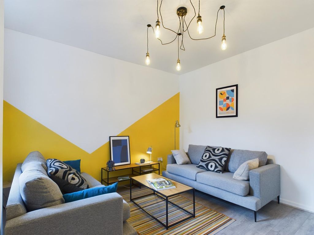 Property photo 1 of 16 Bright And Inviting Living Room Featuring Stylish ...