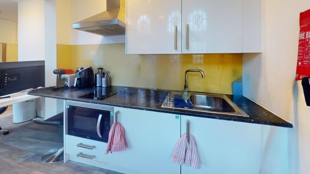 Property photo 2 of 4 A Modern Kitchen Featuring Sleek Cabinetry, Ample ...