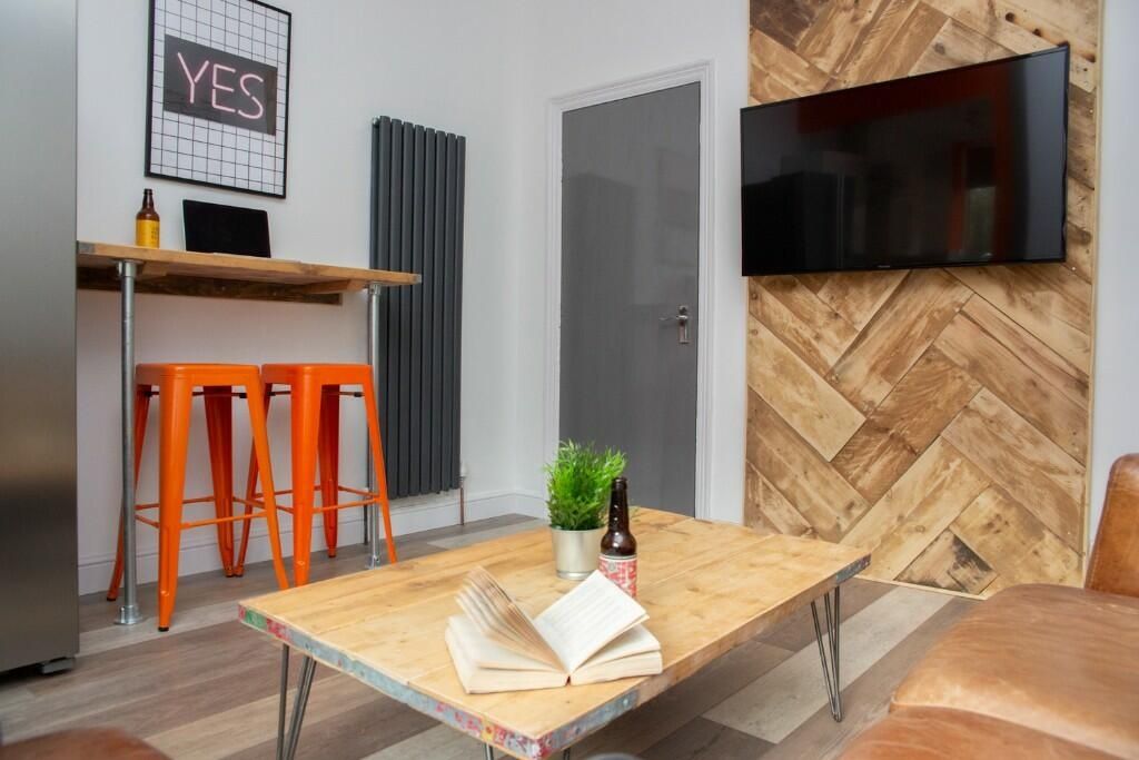 Property photo 3 of 14 A Modern Living Room Featuring A Stylish Wooden He...