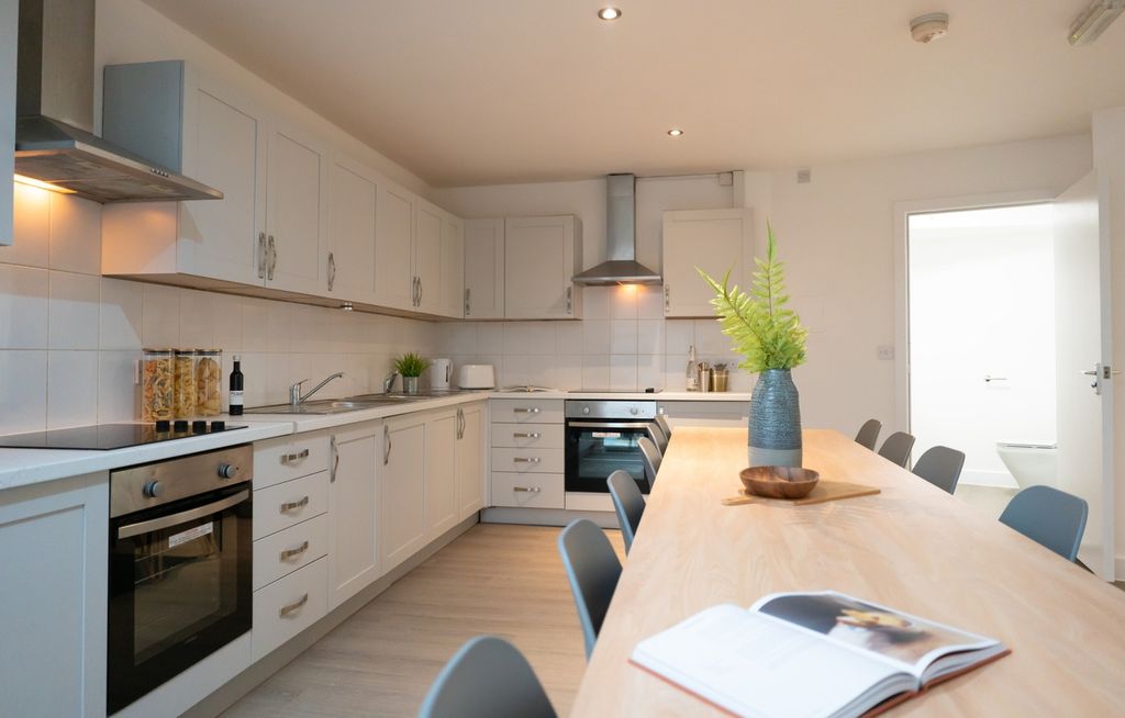 Property photo 3 of 5 Modern Kitchen Featuring Sleek Cabinetry, Ample Co...