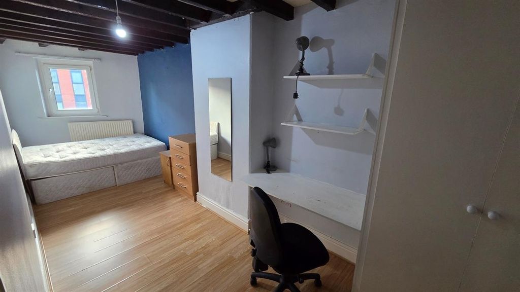 Property photo 1 of 13 A Well-Lit Bedroom Featuring A Comfortable Bed, A ...