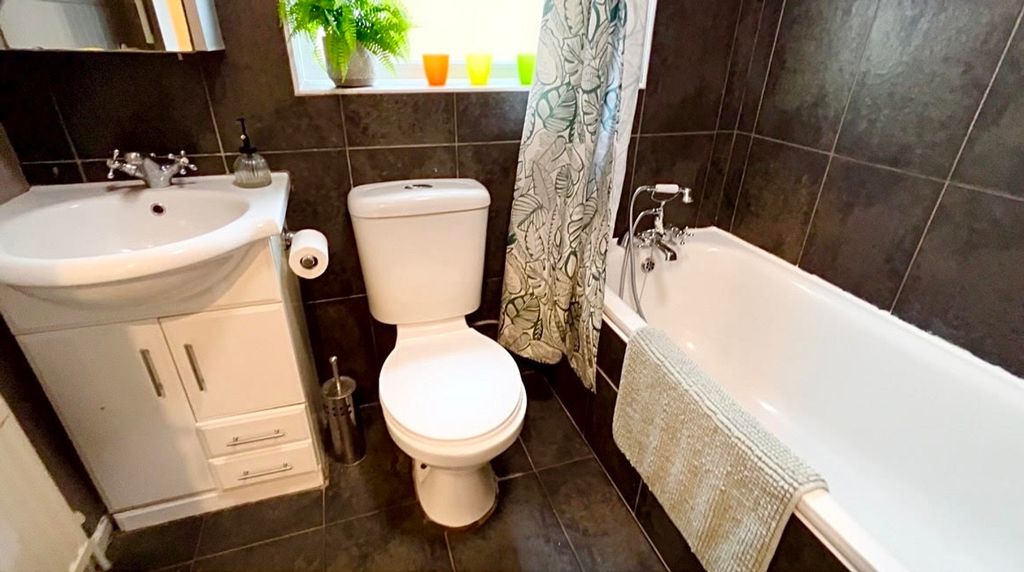 Property photo 2 of 9 A Modern Bathroom Featuring A Sleek Design With A ...