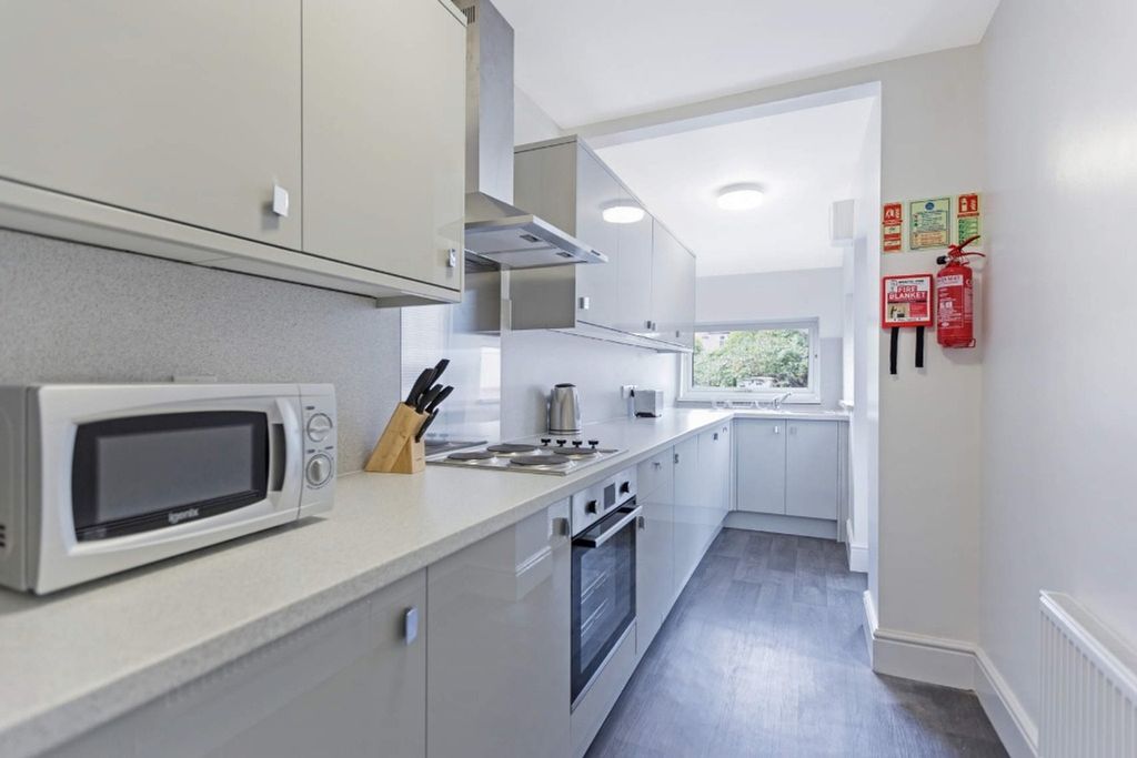 Property photo 3 of 13 A Modern And Tidy Kitchenette Featuring Ample Stor...