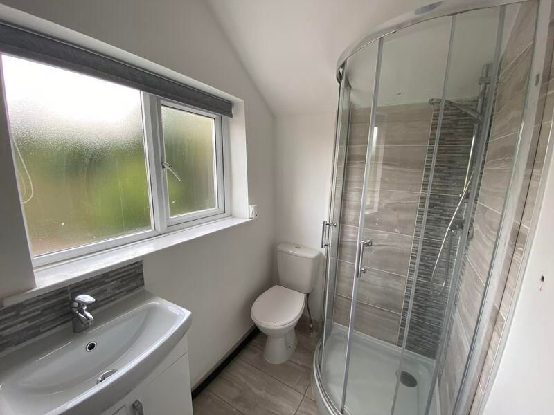 Property photo 2 of 14 A Clean And Bright Bathroom Featuring A Shower Enc...