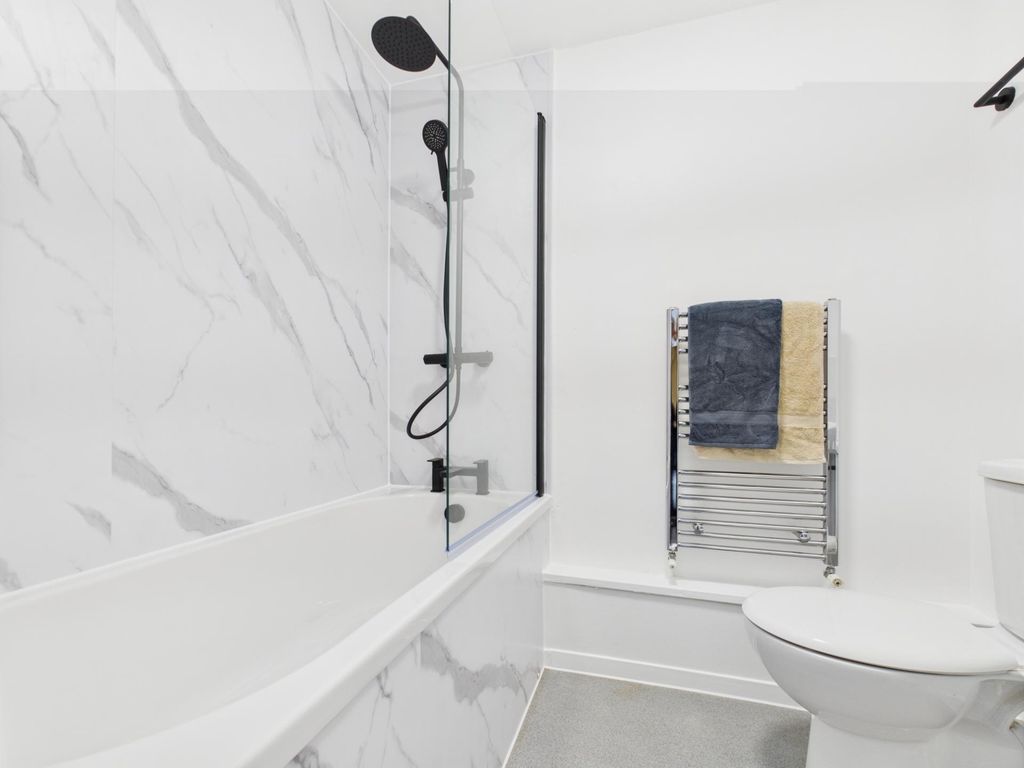 Property photo 3 of 4 Bright Modern Bathroom With A Bathtub And Overhead...