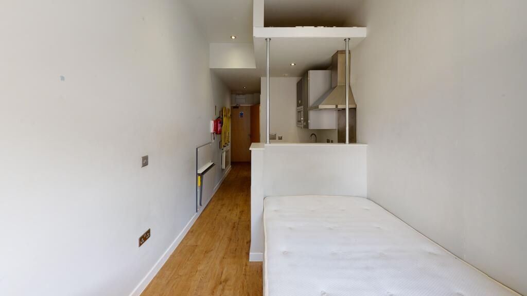 Property photo 3 of 3 A Compact Single Bedroom Featuring A Neat Wooden F...