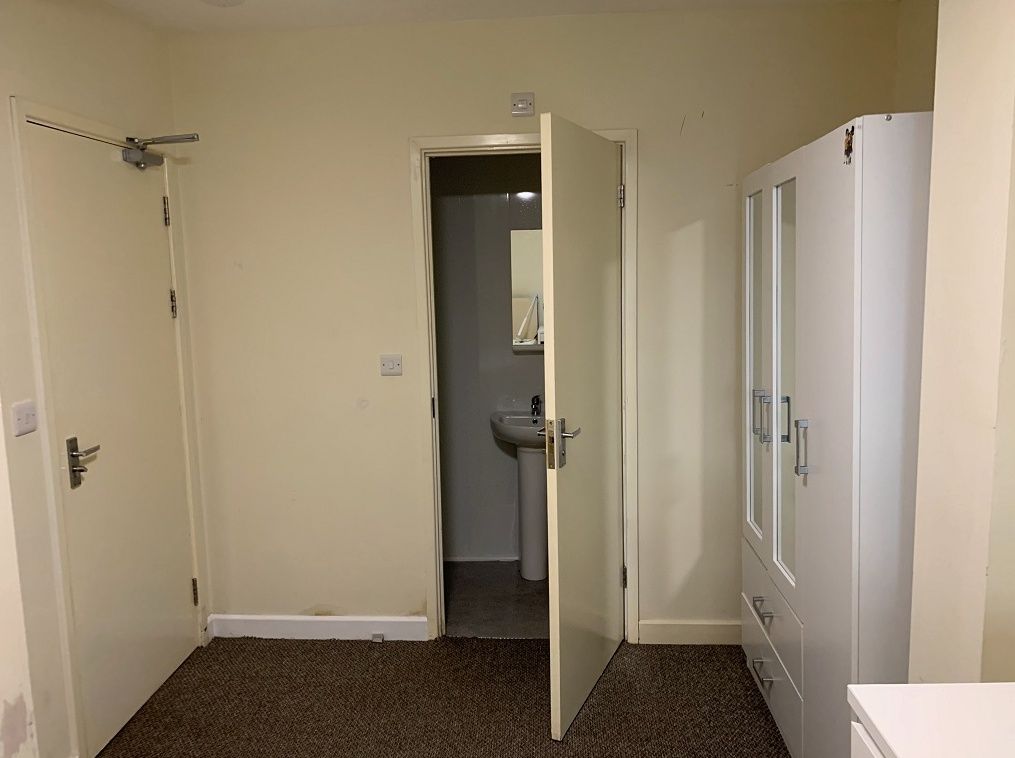 Property photo 1 of 22 A Simple And Functional Room Featuring A Door Lead...
