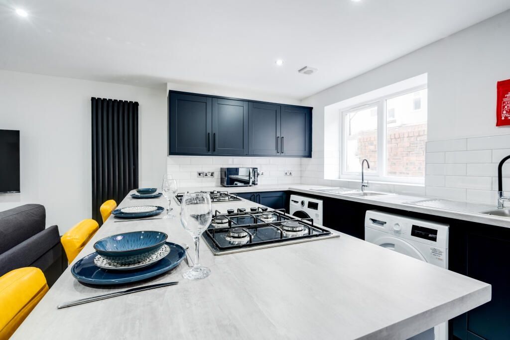 Property photo 1 of 14 Modern Kitchen With Sleek Black Cabinets, Spacious...