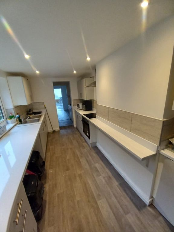 Property photo 3 of 5 Modern Galley Kitchen With Sleek White Countertops...