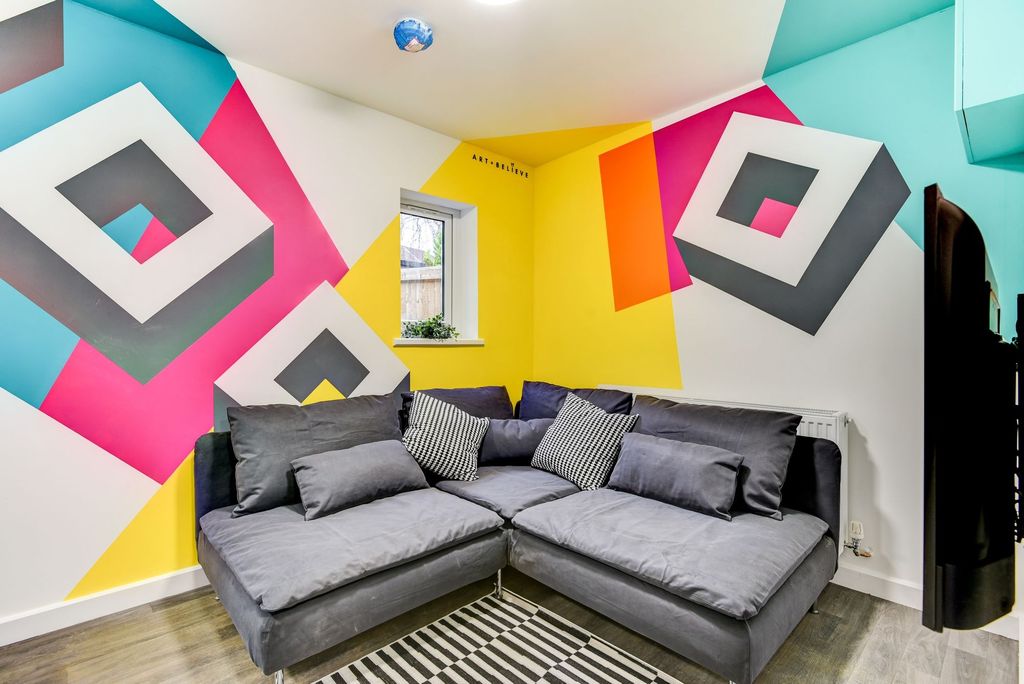 Property photo 2 of 5 A Vibrant Living Room Featuring A Spacious And Coz...