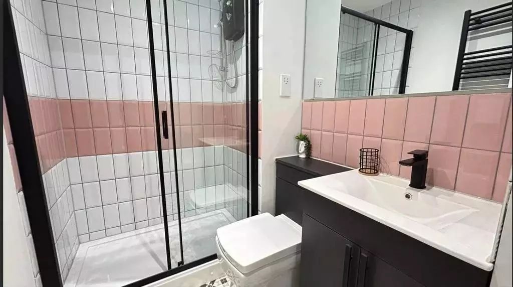 Property photo 1 of 6 Bright And Modern Bathroom Featuring A Sleek Black...