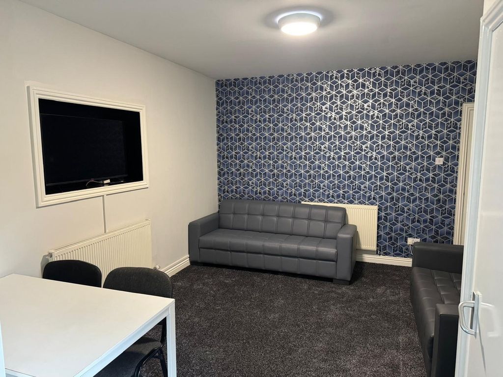 Property photo 2 of 9 A Modern And Inviting Living Room Featuring Stylis...