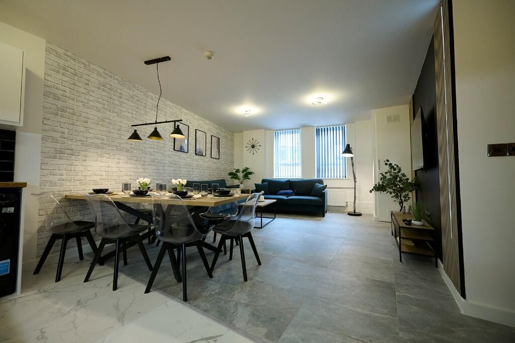 Property photo 2 of 13 A Modern And Spacious Living Room Featuring A Larg...