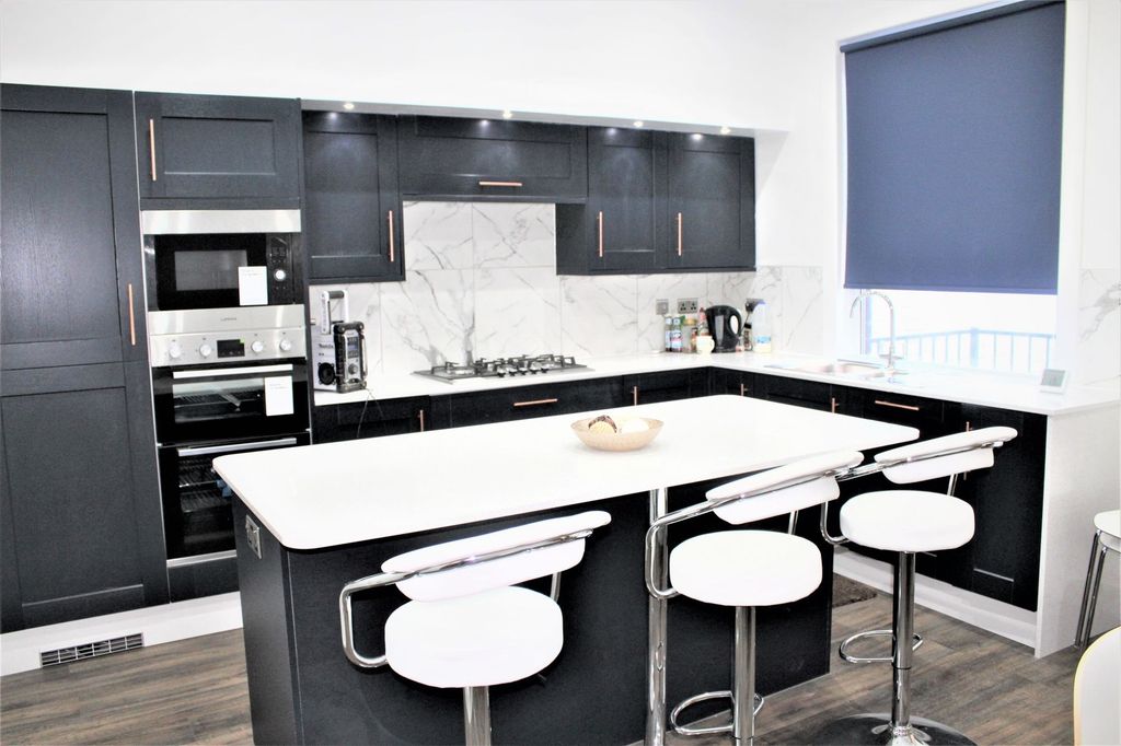 Property photo 1 of 6 Modern Kitchen With Sleek Black Cabinetry, A White...