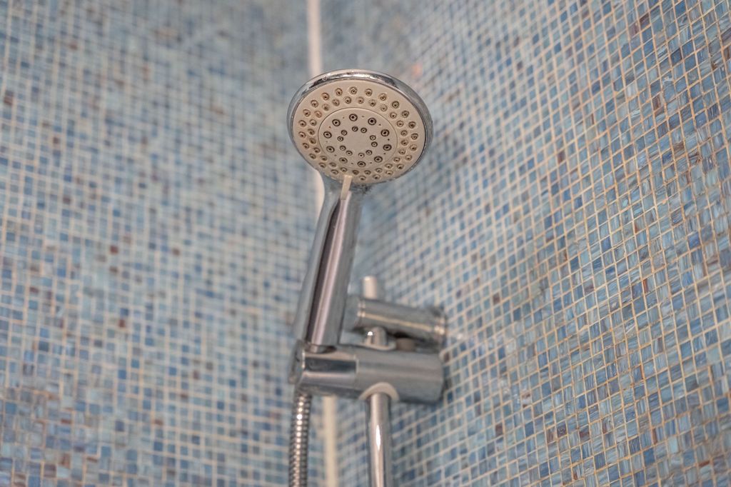 Property photo 2 of 19 Close-Up View Of A Modern Chrome Showerhead Agains...