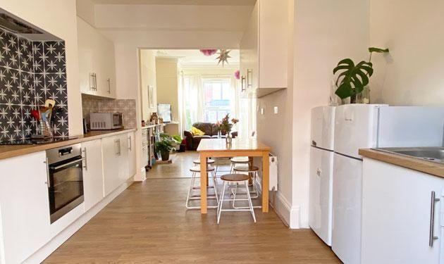 Property photo 2 of 13 Bright Modern Galley-Style Kitchen With White Cabi...