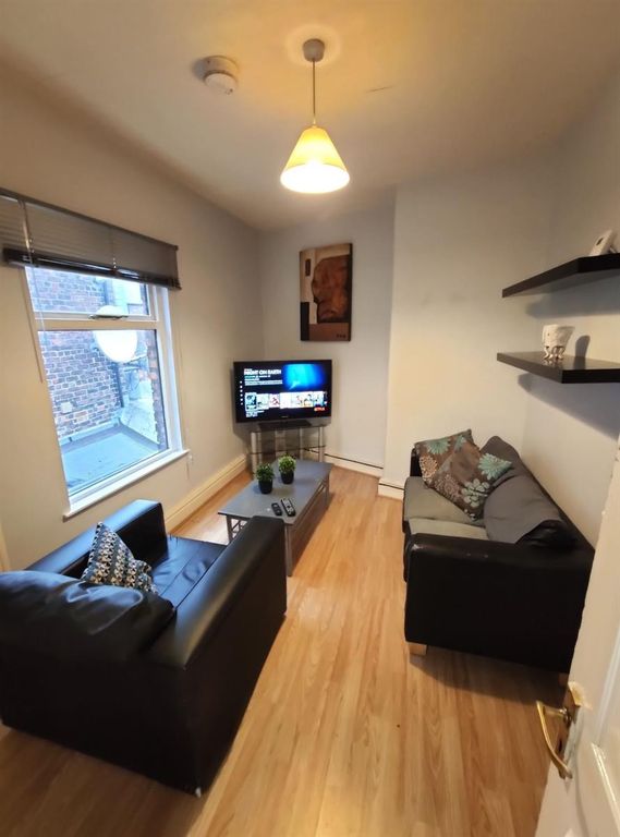 Property photo 2 of 7 A Cozy And Modern Living Room Featuring Comfortabl...