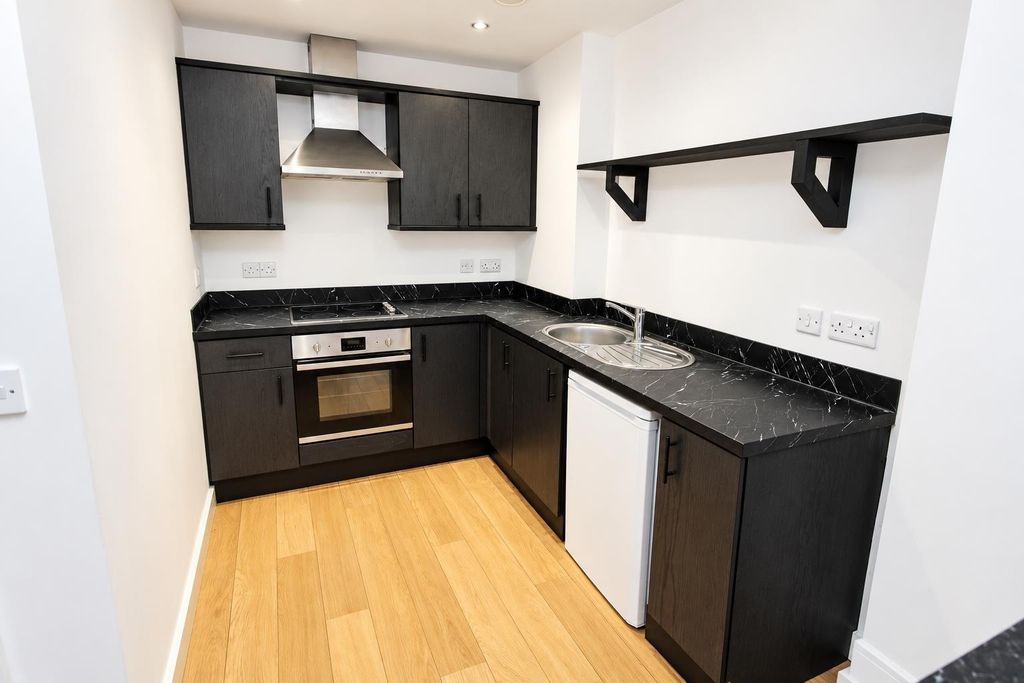 Property photo 2 of 9 Sleek Modern Kitchen With Black Cabinetry...